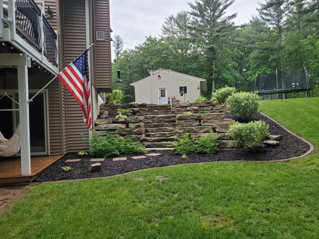 Retaining wall rock style, fresh mulch Garbers & Sons Black River WI