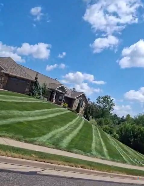 A perfectly manicured lawn in Eau Claire featuring deep, alternating green professional lawn striping patterns.