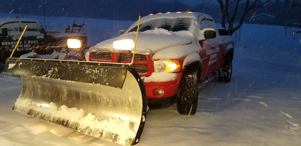 Garbers & Sons plow truck clearing commercial lot in Eau Claire WI