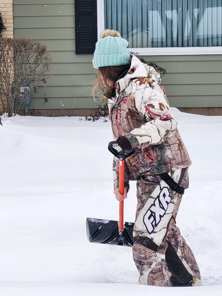 Garbers & Sons crew member clearing snow eau claire wi